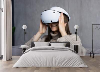 Young woman wear vr glasses s enjoy experience augmented simulation, gaming and futuristic entertainment at home. Wall mural